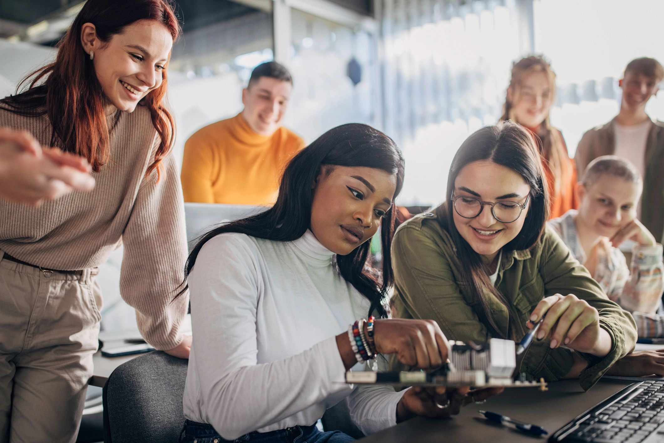 diverse STEM students working together technology