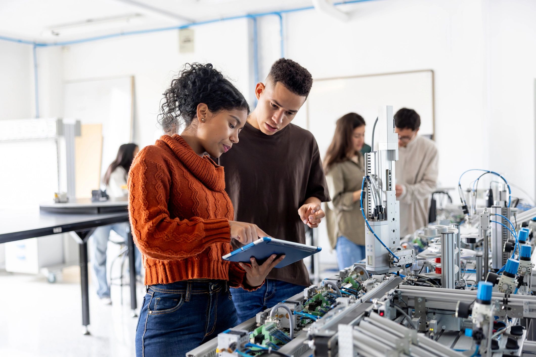 diverse STEM students working together technology